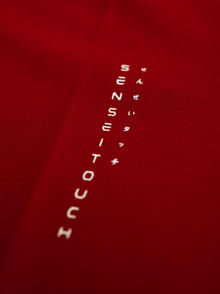 senseitouch logo print on red shirt closeup (7468312756477)